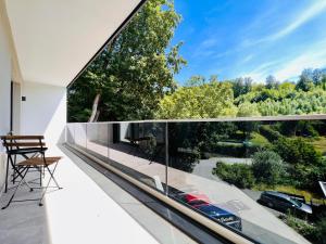 a view from the balcony of a house with glass walls at Idyllische Ferienwohnung mit Balkon & Ausblick in Arzbach