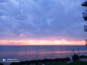 a view of the ocean at sunset at Sunset Apartment in Epanomi