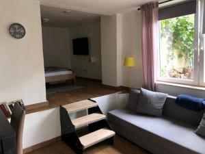 a living room with a couch and a window at Wohnen im Weinberg in Rheinbreitbach