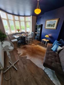 a living room with a couch and a table at Rumer Hill House a unique boutique styled place to stay in Cannock close to A5 the McArthur Glen outlet in Great Wyrley