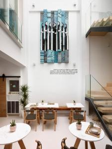 a dining room with tables and chairs and stairs at LD Convento Cister in Málaga