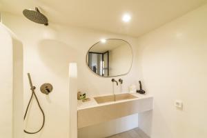 a bathroom with a sink and a mirror at Yasemi in Argostoli