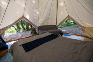a tent with a bed in the middle at Naturally Glamping in Kingsteignton
