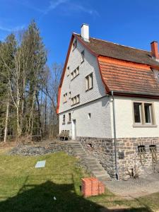 a large white building with a red roof at Schellnhof Forsthaus am Waldrand in Nidda