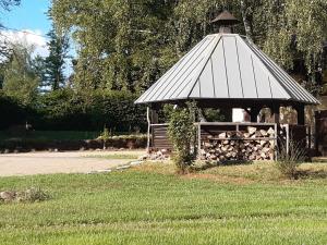 a gazebo with a pile of fire wood at Schellnhof Forsthaus am Waldrand in Nidda