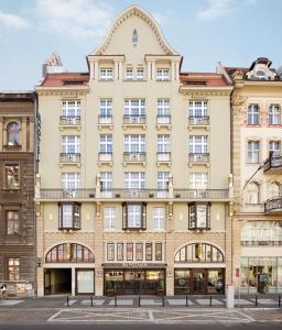 a large beige building with a balcony at Hotel NH Poznan in Poznań