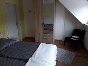 a bedroom with a bed and a chair and a staircase at Ruff un Runner in Morbach