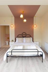 a bedroom with a large bed with a black frame at The Kitbag in West Runton
