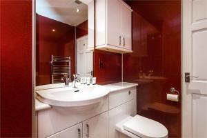 a bathroom with a white sink and a toilet at Chapel Street 42B First floor 1-bedroom apartment, Aberdeen city center in Aberdeen