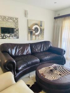 a brown leather couch in a living room at Unit 3, Marine Terrace in Margate