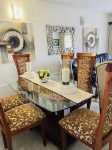 a dining room with a glass table and chairs at Unit 3, Marine Terrace in Margate