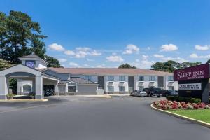 a hotel with a sign in a parking lot at Sleep Inn & Suites Chesapeake - Portsmouth in Chesapeake