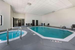 a swimming pool in a large room with a pool at Sleep Inn & Suites Chesapeake - Portsmouth in Chesapeake