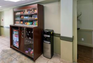 a refrigerator in a room next to a wall at Quality Inn & Suites in Whitecourt