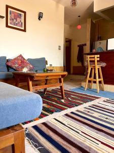 a living room with a couch and a table at Luna House Asala Beach in Dahab