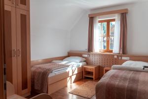 a bedroom with two beds and a window at Luxury Apartments Bolf in Hočko Pohorje