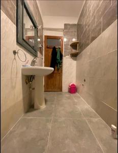 a bathroom with a white sink and a mirror at Luna House Asala Beach in Dahab