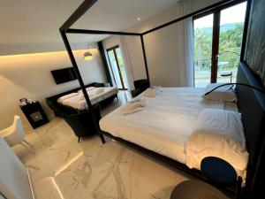 a bedroom with a large bed and a window at Hotel Alpha in Sant'Agnello