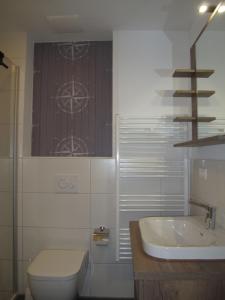 a bathroom with a toilet and a sink at Holiday Home Cuxland Ferienpark-5 by Interhome in Wremen