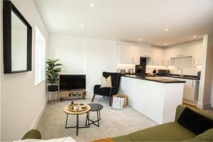 an open living room with a kitchen and a living room at Boutique Apartments Torquay Overlooking Harbour - Near Babbacombe & Beach by Belvilla in Torquay
