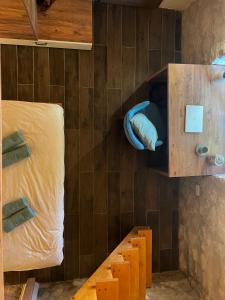 a small room with a bed and a wooden cabinet at Kostela Stone House in Stolac
