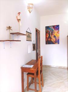 a room with a wooden table and a desk at Zanzicrown in Nungwi