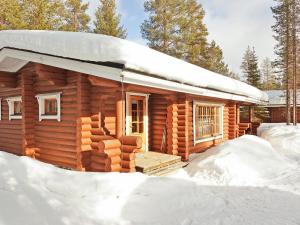 a log cabin is covered in snow at Holiday Home Sirkan ojus 1 by Interhome in Sirkka