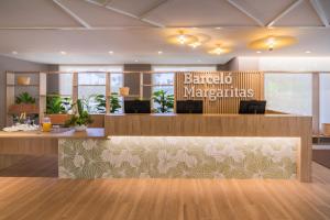 an office lobby with a reception desk and a sign that reads barcelona hypermarkets at Barceló Margaritas in Playa del Ingles