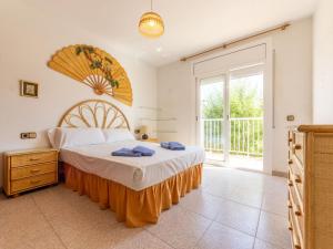 a bedroom with a bed and a large window at Holiday Home Residencial Port Lligat by Interhome in Torredembarra