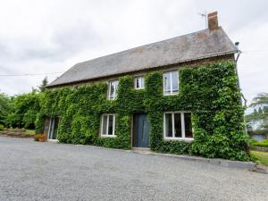 an ivy covered house with a driveway at Holiday Home Le bois bourdin by Interhome in Pontorson