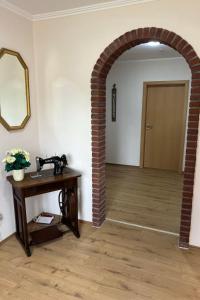 an archway in a room with a table and a mirror at Holiday Home Kettler by Interhome in Weener