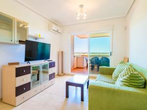 A television and/or entertainment centre at Apartment Jardines del Mar III - Marina d'Or-4 by Interhome