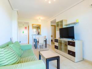 A television and/or entertainment centre at Apartment Jardines del Mar III - Marina d'Or-4 by Interhome