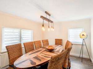 a dining room with a wooden table and chairs at Holiday Home Dunja by Interhome in Hain +19 photos
