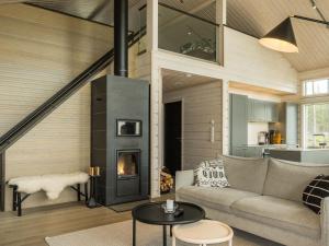a living room with a fireplace in a house at Holiday Home Merilänranta by Interhome in Manamansalo
