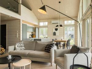 a living room with a couch and a table at Holiday Home Merilänranta by Interhome in Manamansalo