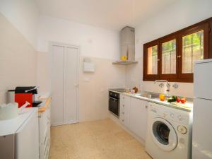 a kitchen with a washing machine and a sink at Holiday Home Marisol Park by Interhome in Calpe