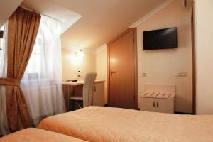 a hotel room with a television and a bed at Gonchar Hotel in Kyiv
