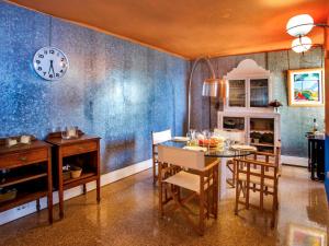 a dining room with a table and a clock on the wall at Apartment Torre del Castillo by Interhome in Jávea