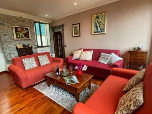 a living room with red couches and a coffee table at Holiday Home Casa Alfonso by Interhome in Pietrabruna
