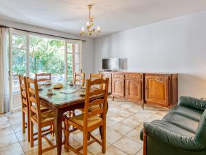 kuchnia i jadalnia ze stołem i krzesłami w obiekcie Holiday Home Dominique by Interhome w mieście Lacanau-Océan
