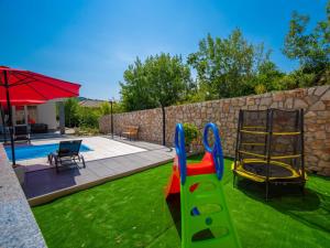 a backyard with a playground with a slide at Holiday Home Olivia by Interhome in Bribir
