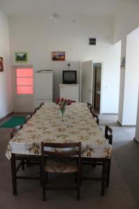 a dining room table with flowers on top of it at Peregi Vendégház in Mezőhegyes +17 photos