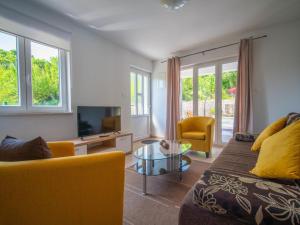 a living room with a couch and a tv at Holiday Home Olivia by Interhome in Bribir