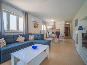 a living room with a blue couch and a table at Holiday Home Olivia by Interhome in Bribir
