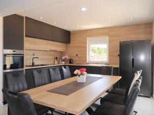 a kitchen with a wooden table and black appliances at Holiday Home Emili & Elias by Interhome in Karlobag