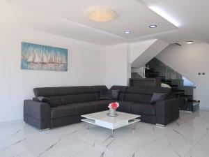 a living room with a couch and a table at Holiday Home Emili & Elias by Interhome in Karlobag