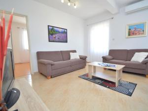 a living room with two couches and a coffee table at Holiday Home Katenas by Interhome in Šibenik