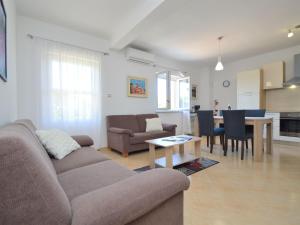 a living room with a couch and a table at Holiday Home Katenas by Interhome in Šibenik