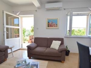 a living room with a couch and a table at Holiday Home Katenas by Interhome in Šibenik +26 photos